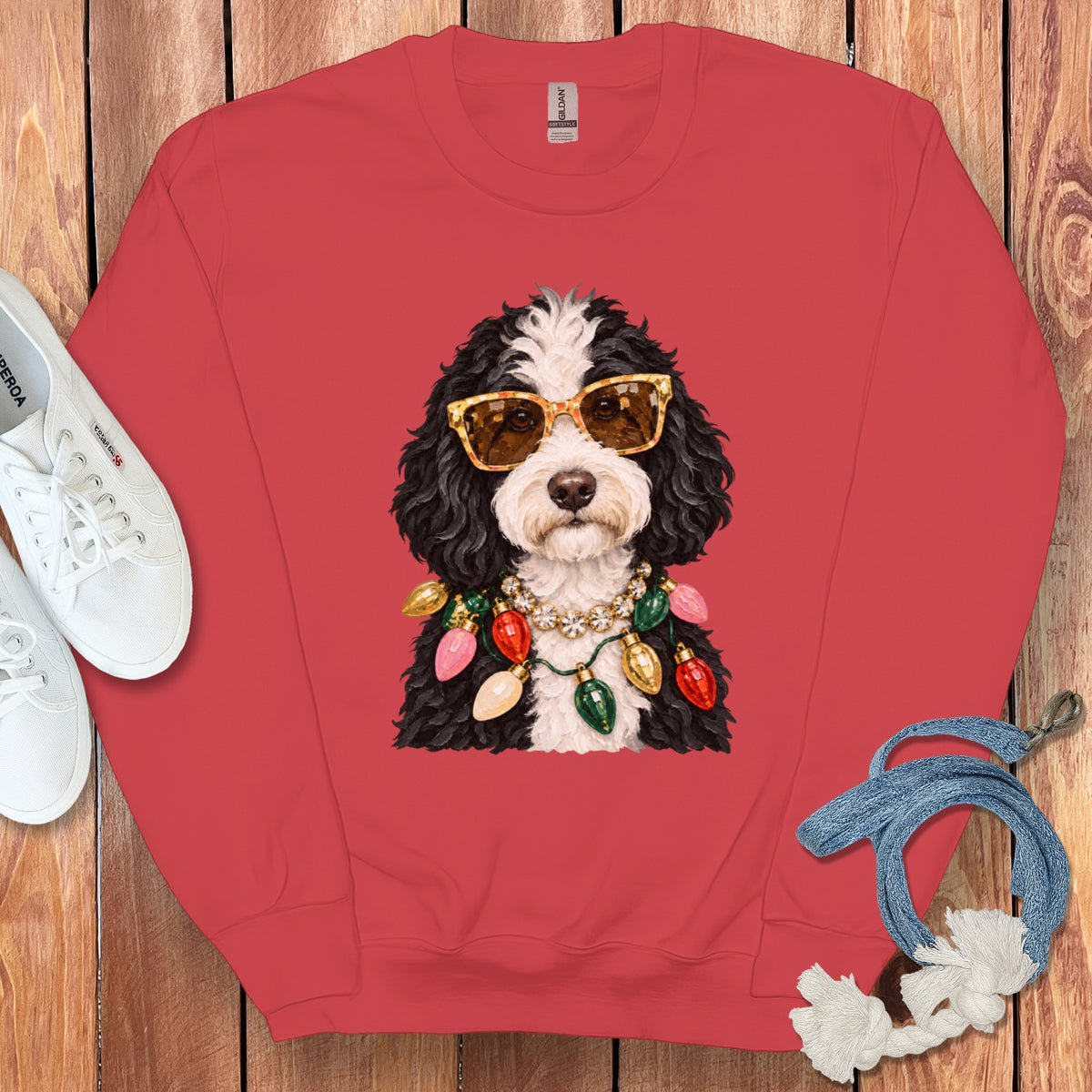Red sweatshirt with a doodle dog wearing sunglasses and Christmas lights.
