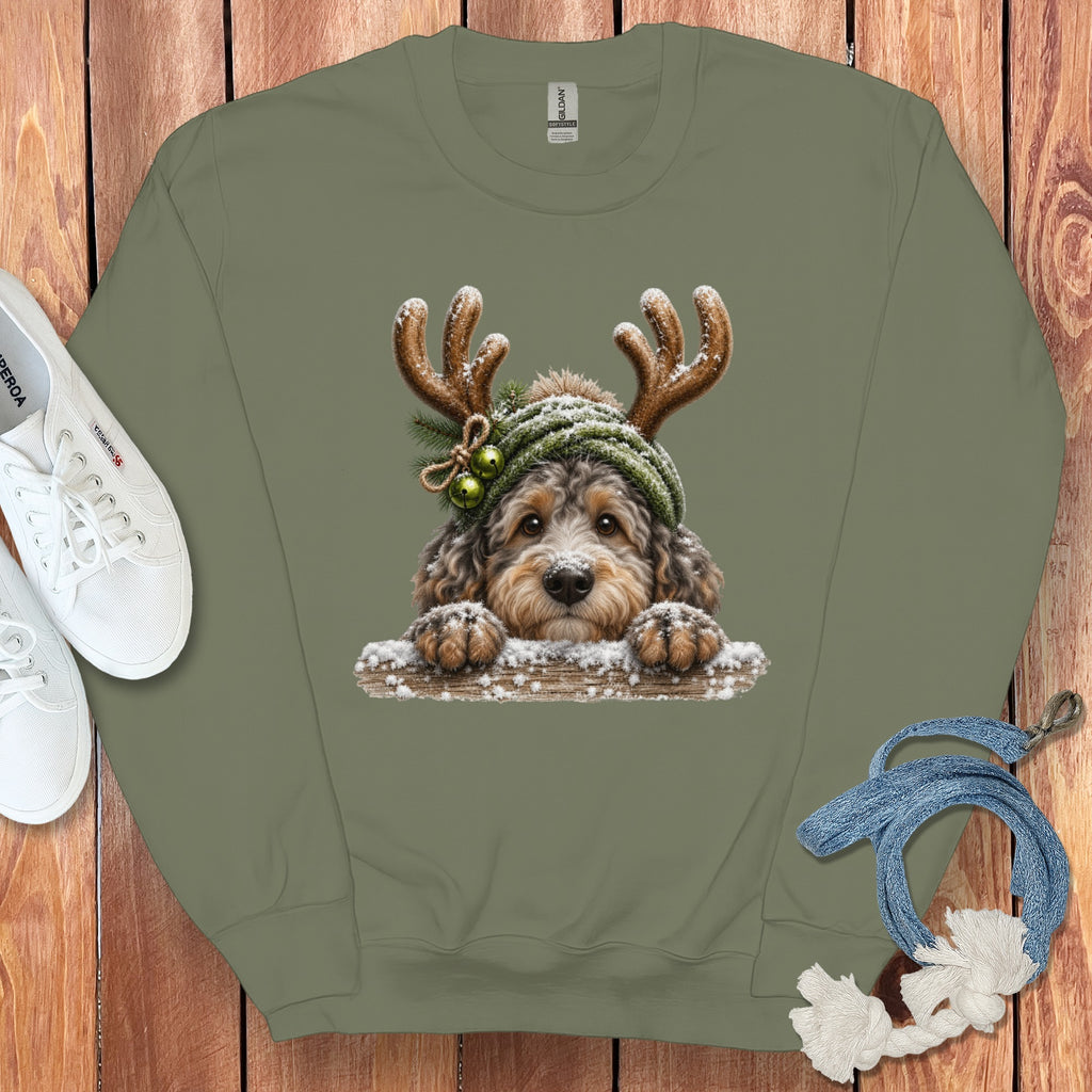 Crewneck sweatshirt with a doodle dog wearing antlers and a festive hat.