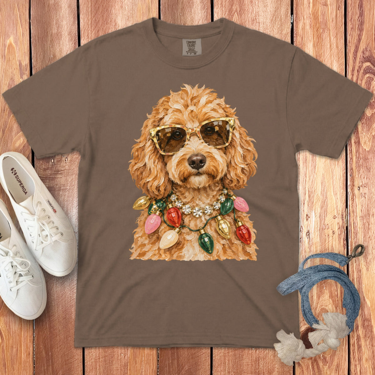 Brown t-shirt with watercolor print of a dog wearing sunglasses and Christmas lights.