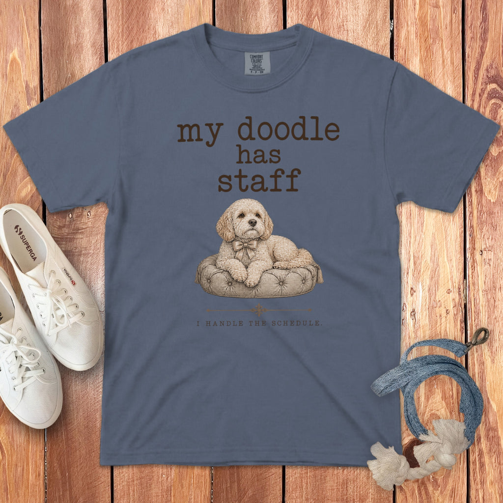 Blue t-shirt with text "my doodle has staff" and a dog on a pillow.