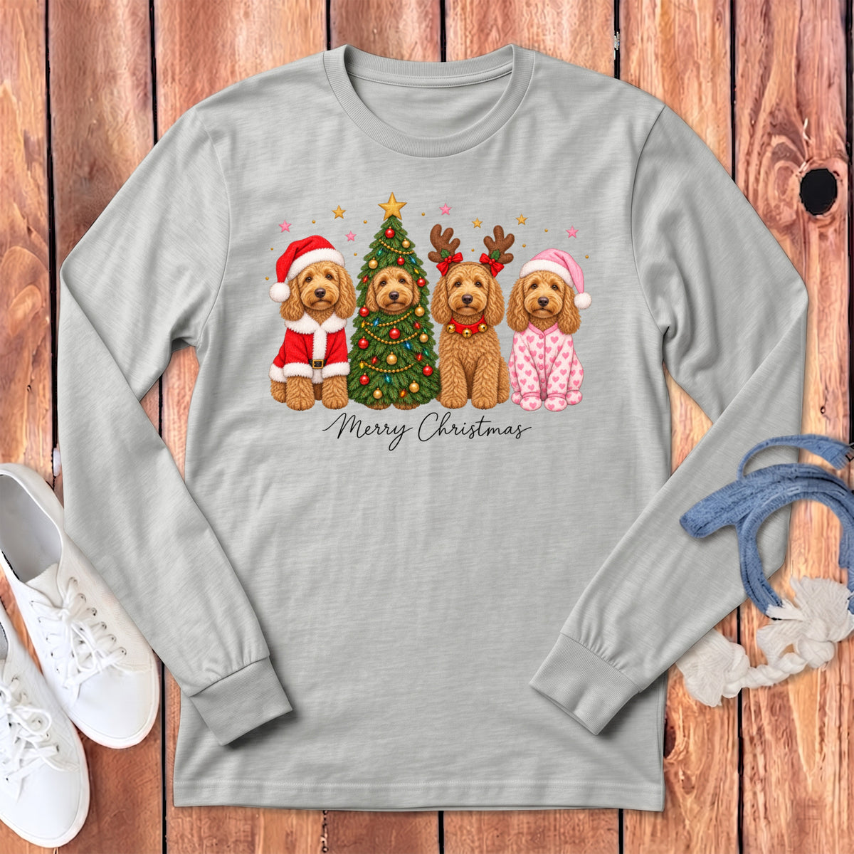 A light gray long-sleeve t-shirt features a graphic of four doodle dogs celebrating Christmas, with the text Merry Christmas below them.