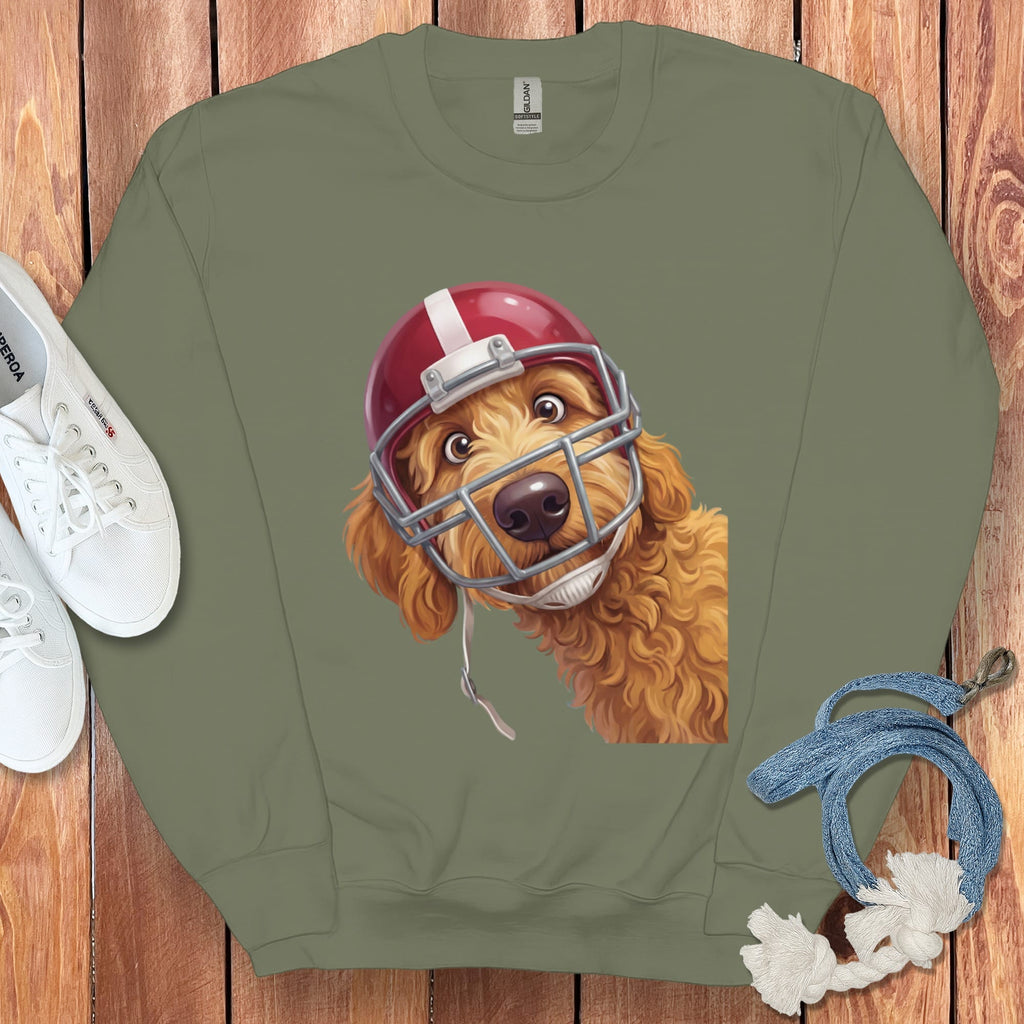 Goldendoodle dog wearing a red and silver football helmet, printed on a green sweatshirt.