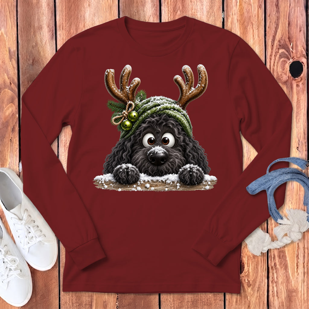 Black dog with antlers, green hat, and snow on a maroon long-sleeved shirt.