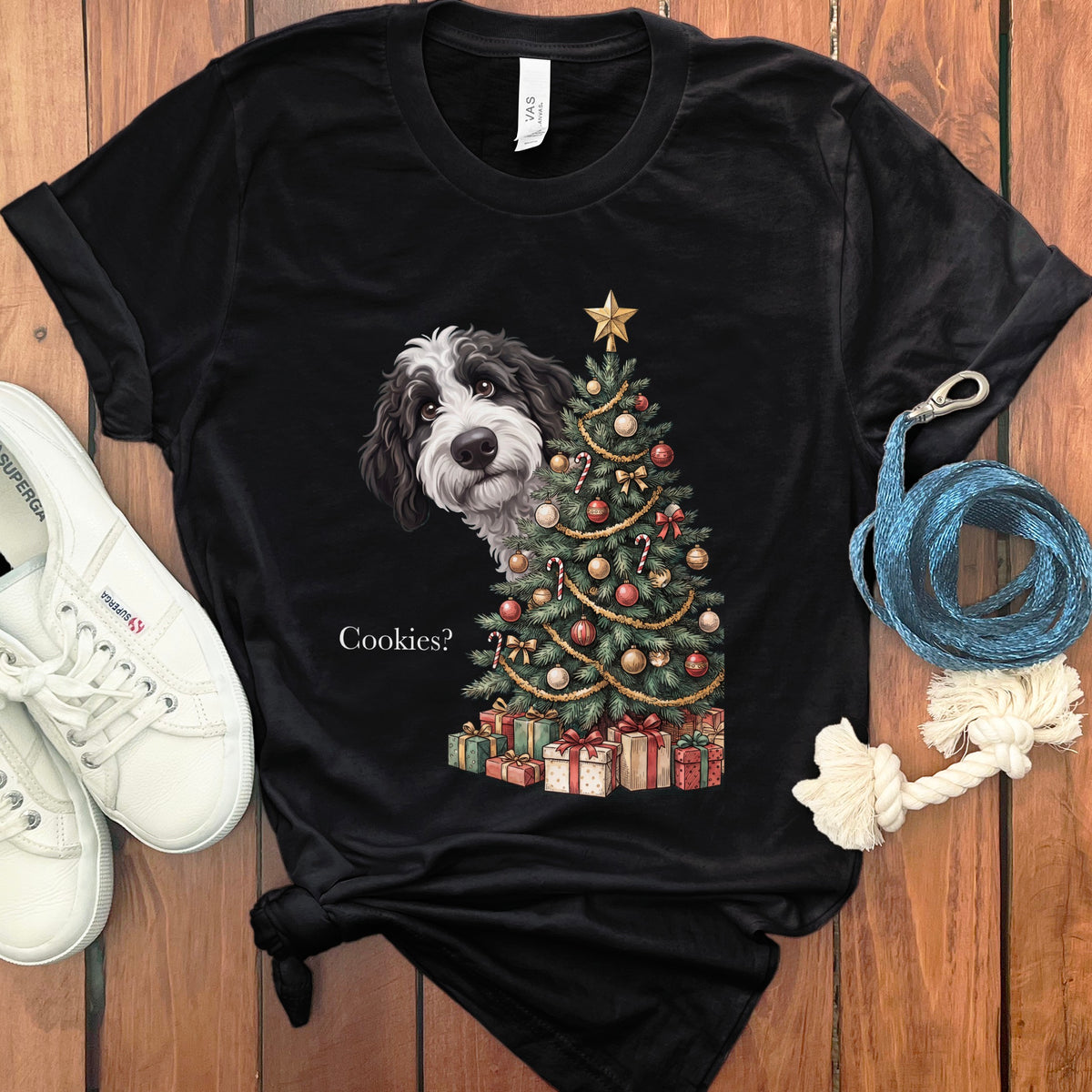 Black t-shirt with a dog peeking from behind a Christmas tree.