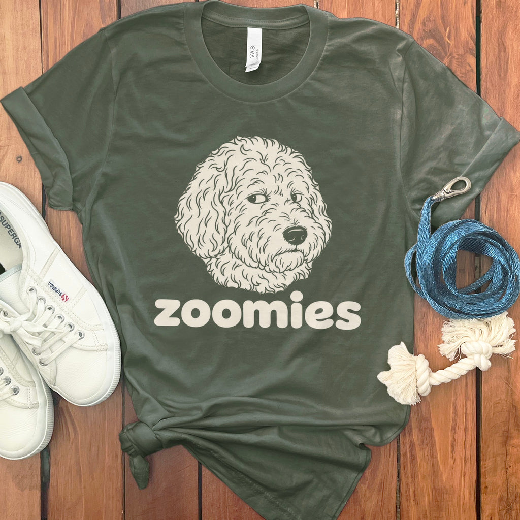 Green t-shirt with a doodle dog illustration and the word "zoomies".