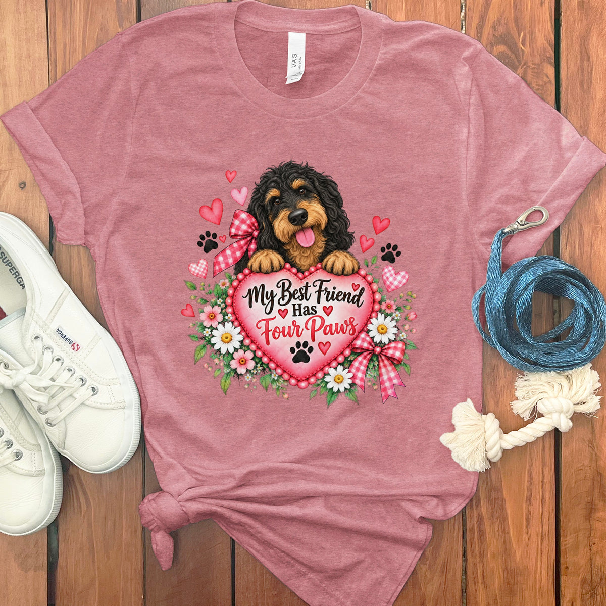 Dusty pink t-shirt featuring a doodle dog graphic, hearts, flowers, and the text My Best Friend Has Four Paws.