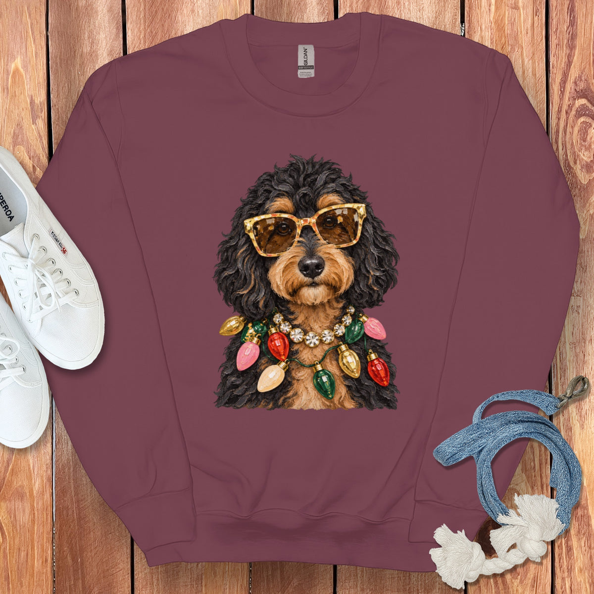 Maroon sweatshirt featuring a dog wearing sunglasses and a string of Christmas lights.