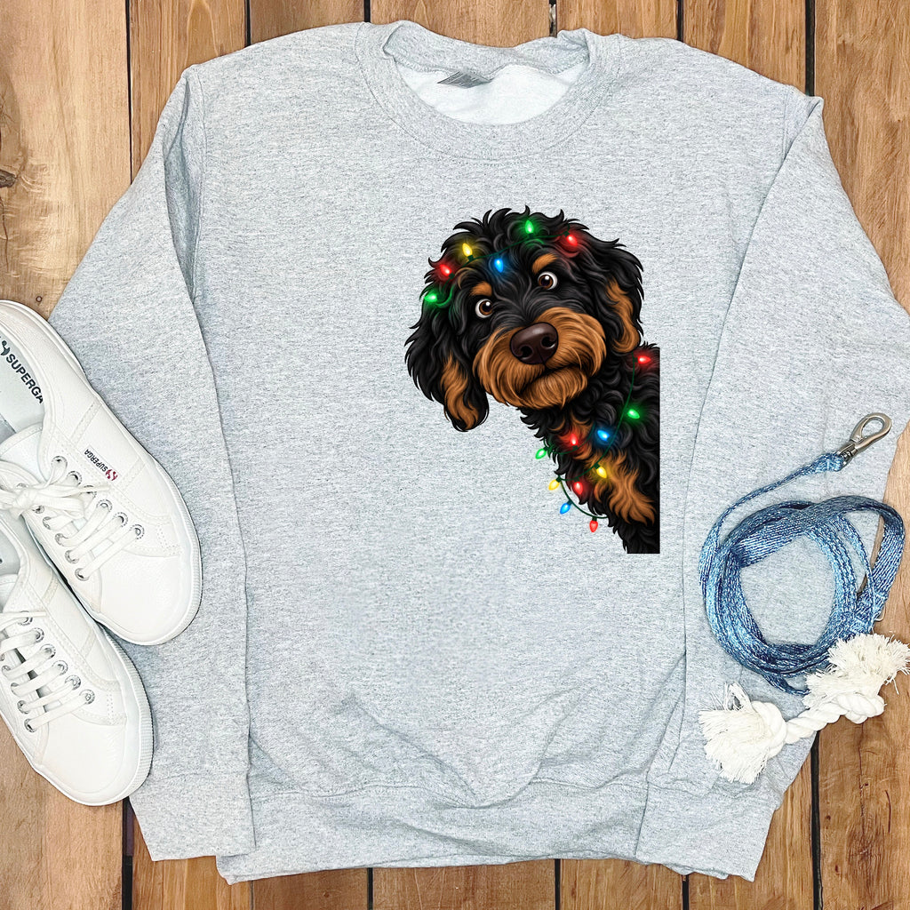 Grey sweatshirt with a cartoon dog wearing colorful Christmas lights.
