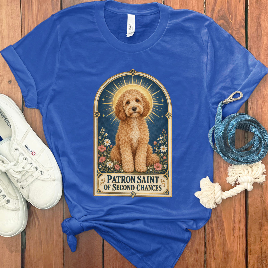 Blue t-shirt with illustration of a goldendoodle titled "Patron Saint of Second Chances."