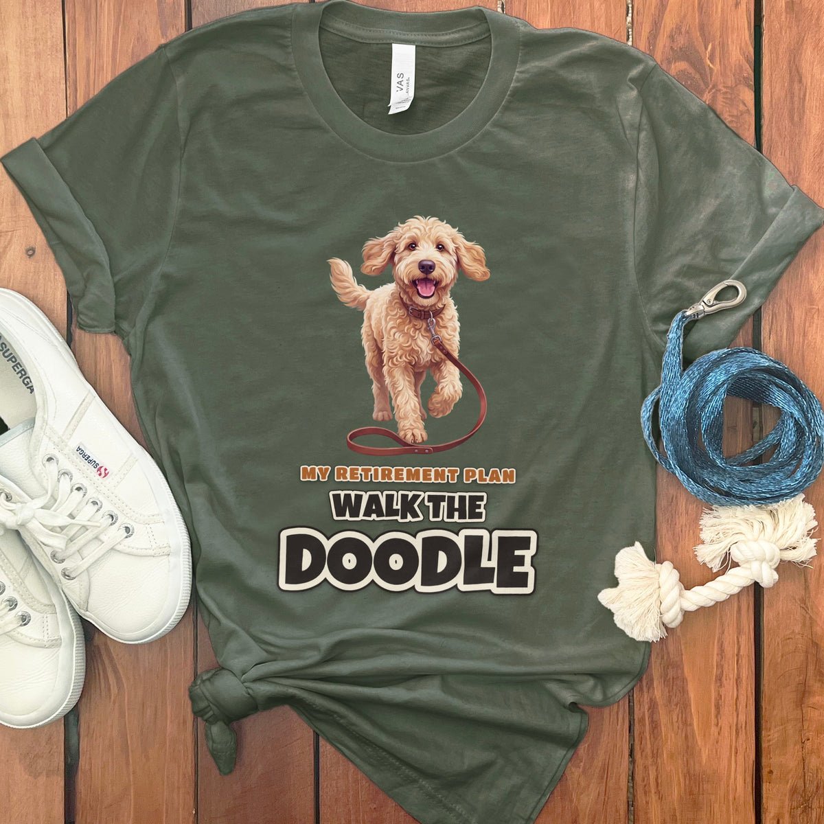 Green t-shirt with "My Retirement Plan Walk The Doodle" text and doodle dog illustration.