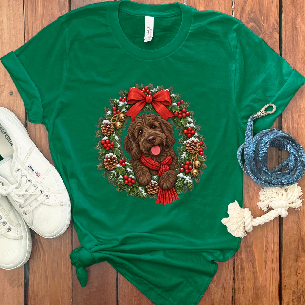 Green t-shirt featuring a doodle dog graphic inside a Christmas wreath, accompanied by sneakers and a leash.