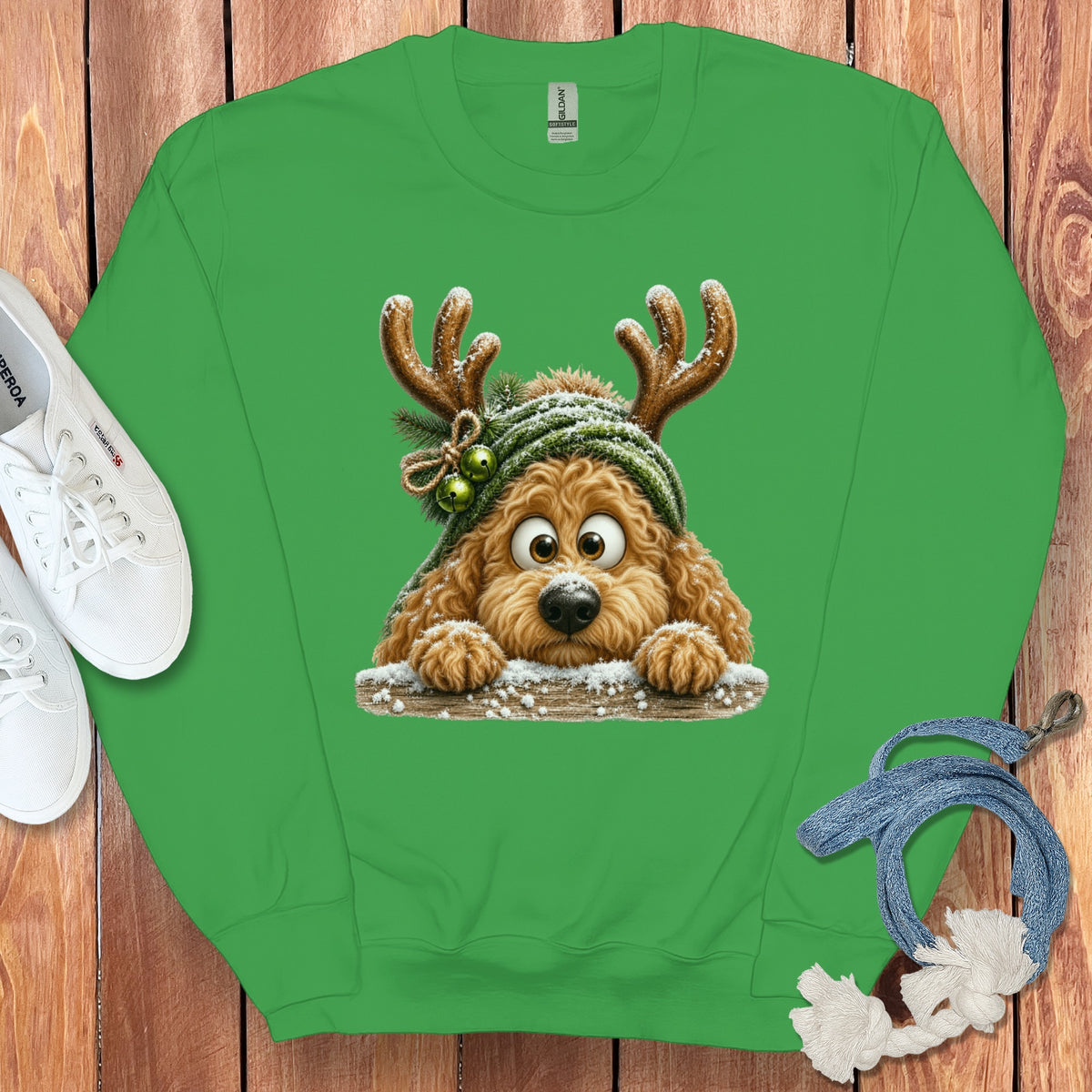Green sweatshirt with cartoon dog wearing antlers and a knitted hat.