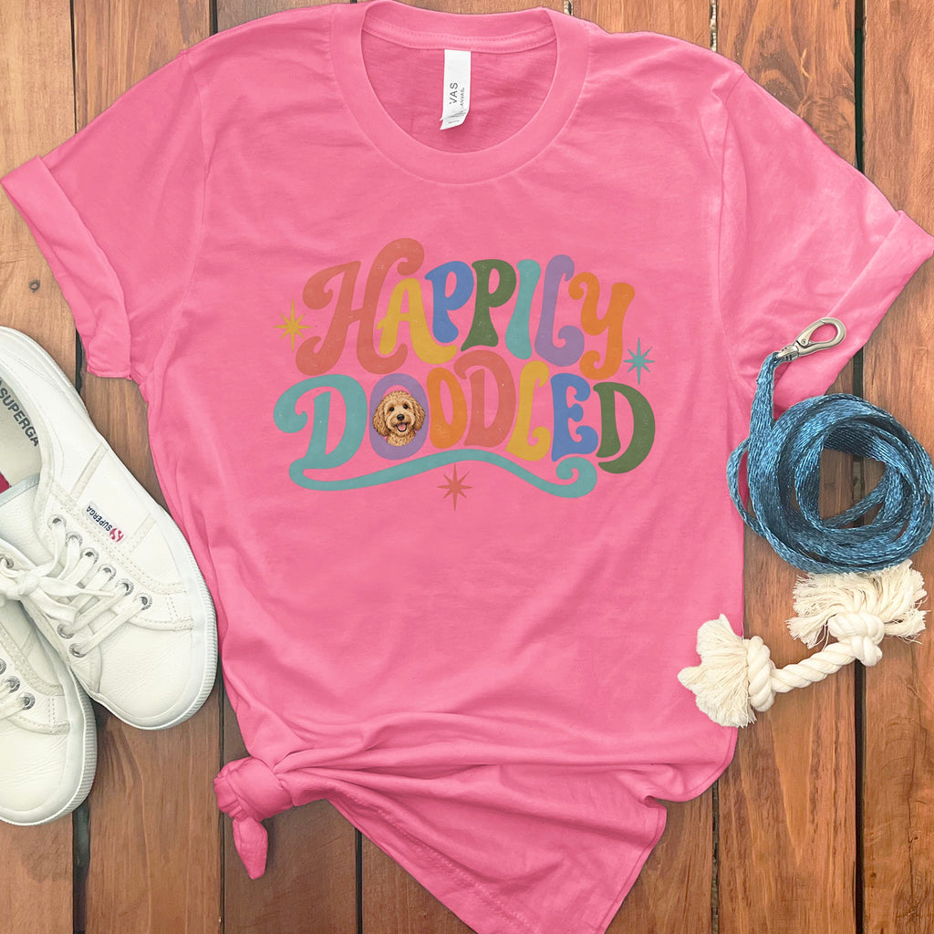 Pink t-shirt with "Happily Doodled" text and a doodle dog graphic.