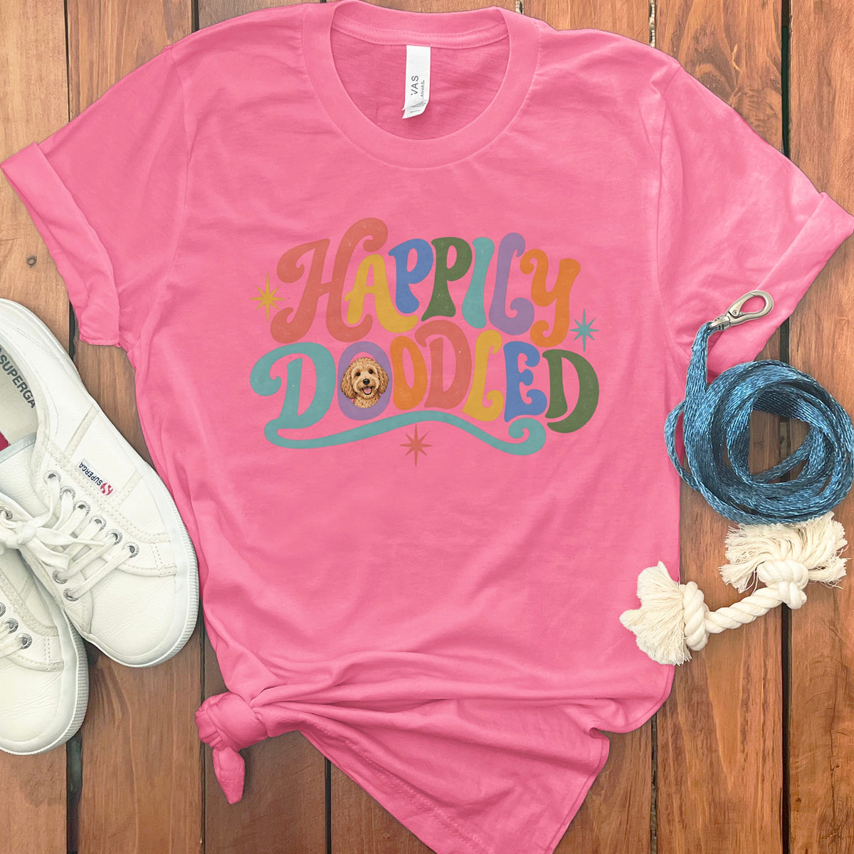Pink t-shirt with "Happily Doodled" text and a doodle dog graphic.