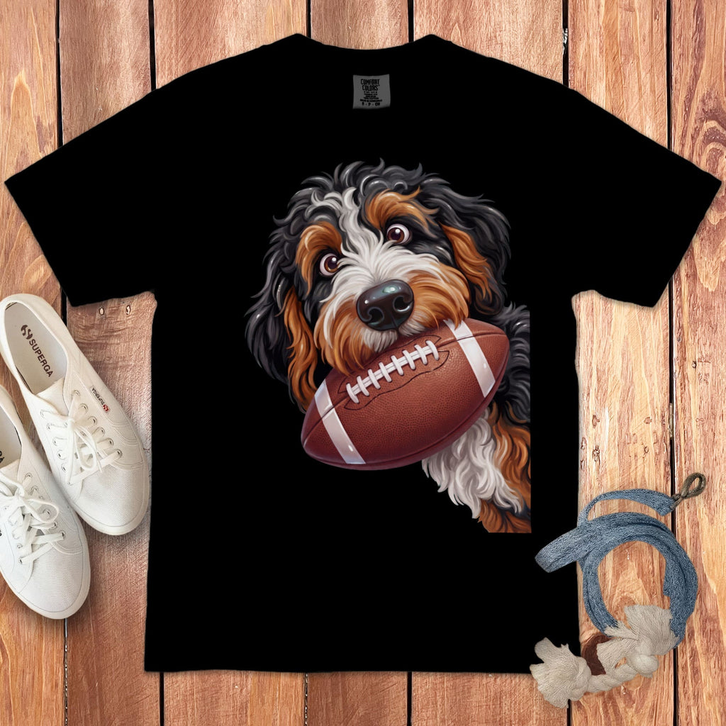Black t-shirt with a Bernese Mountain Dog holding a football in its mouth.
