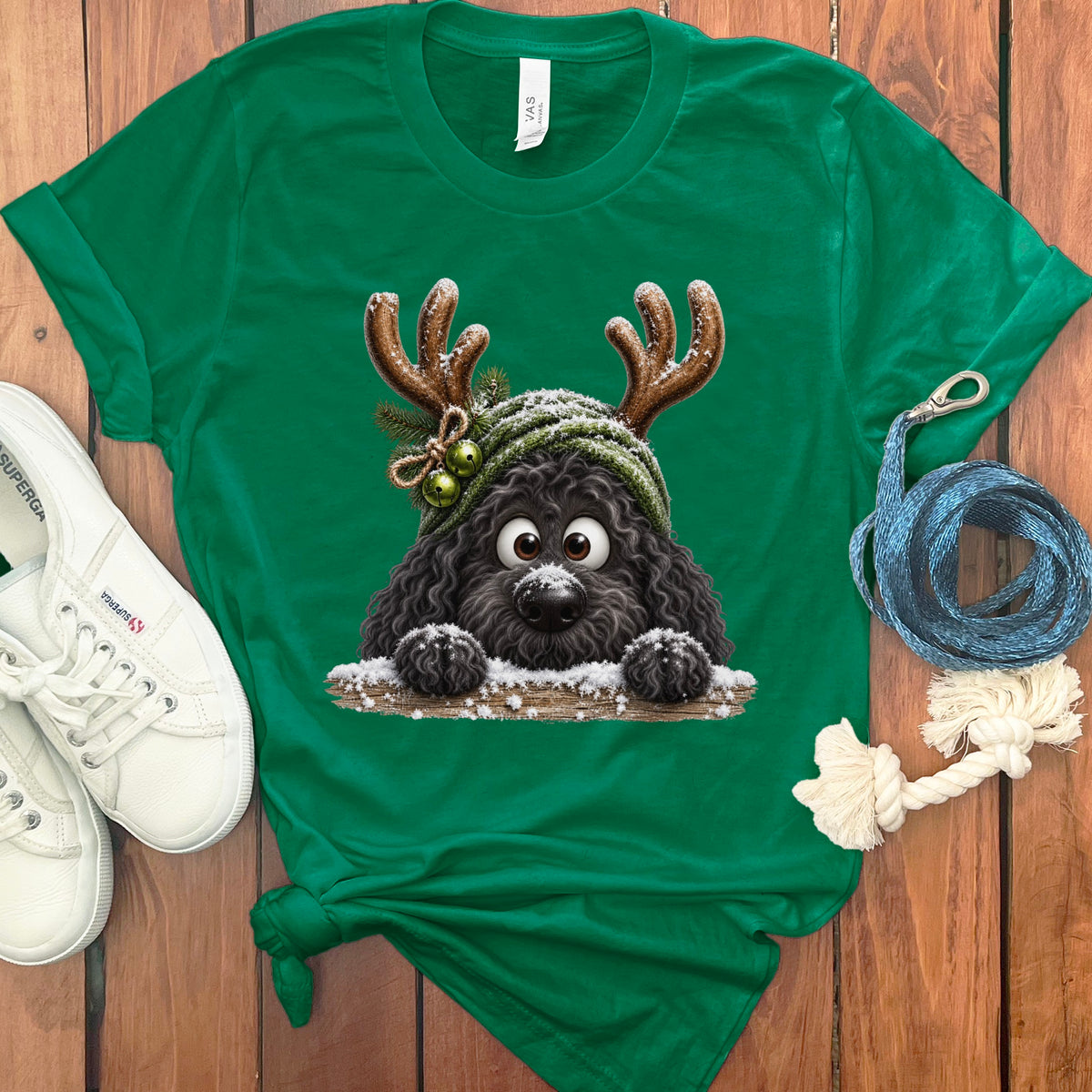 Green t-shirt with a black poodle wearing a Christmas hat and reindeer antlers.