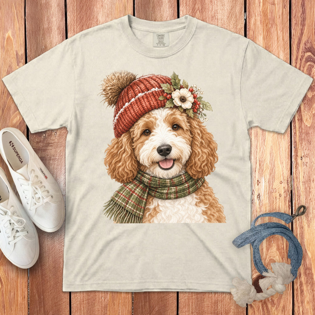 Cream t-shirt with a watercolor illustration of a dog wearing a hat and scarf.