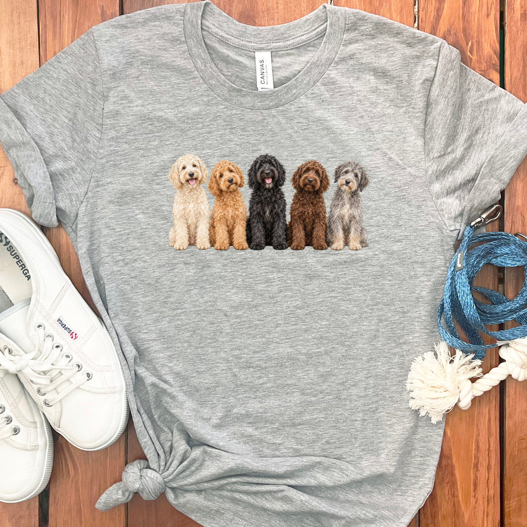 Grey t-shirt with a watercolor print of five fluffy dogs in varying colors.