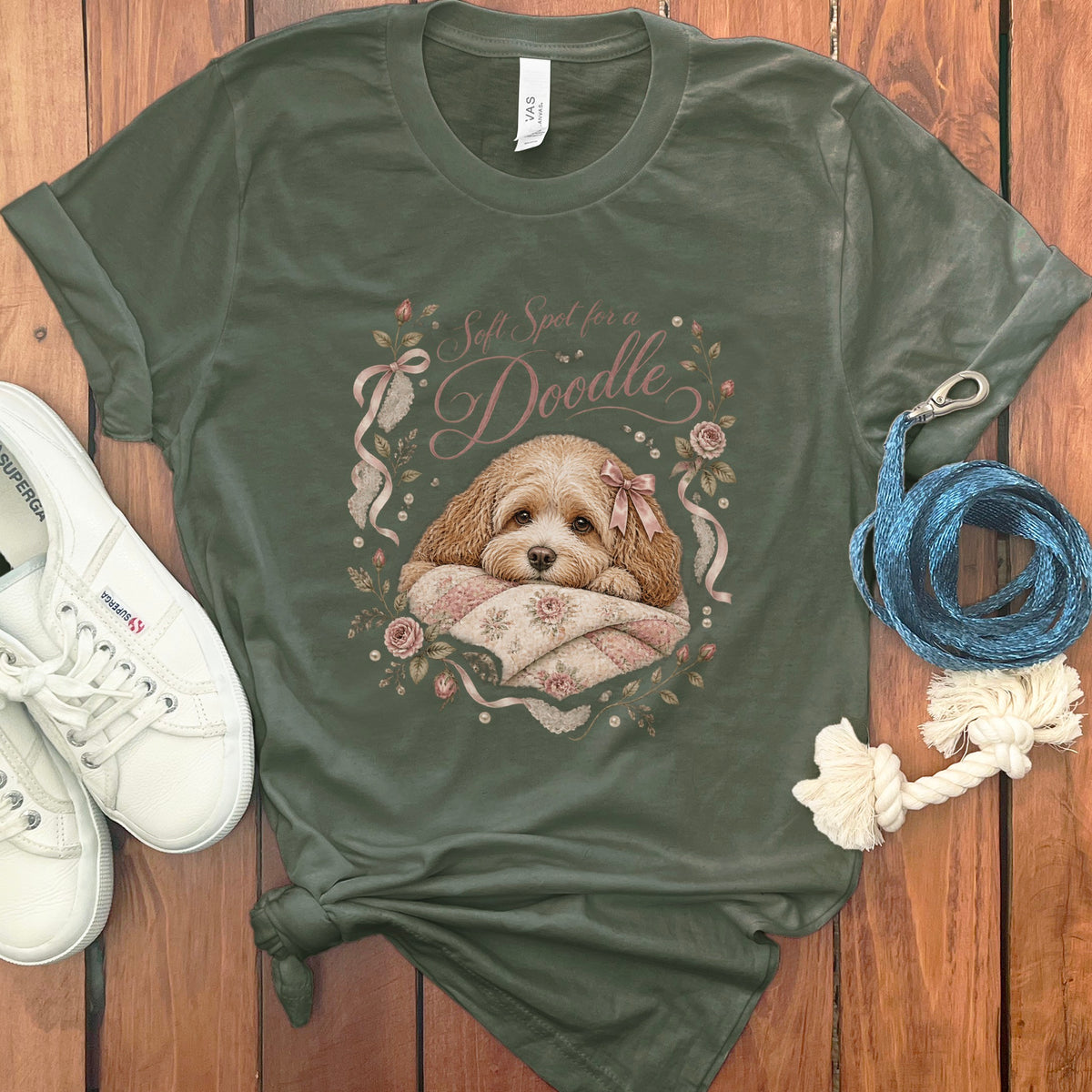 Green t-shirt with a doodle dog and floral wreath graphic reading "Soft Spot for a Doodle".