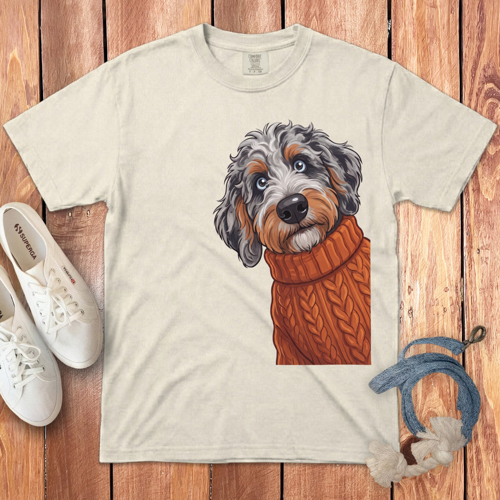 Cream t-shirt with doodle dog wearing an orange sweater as graphic.