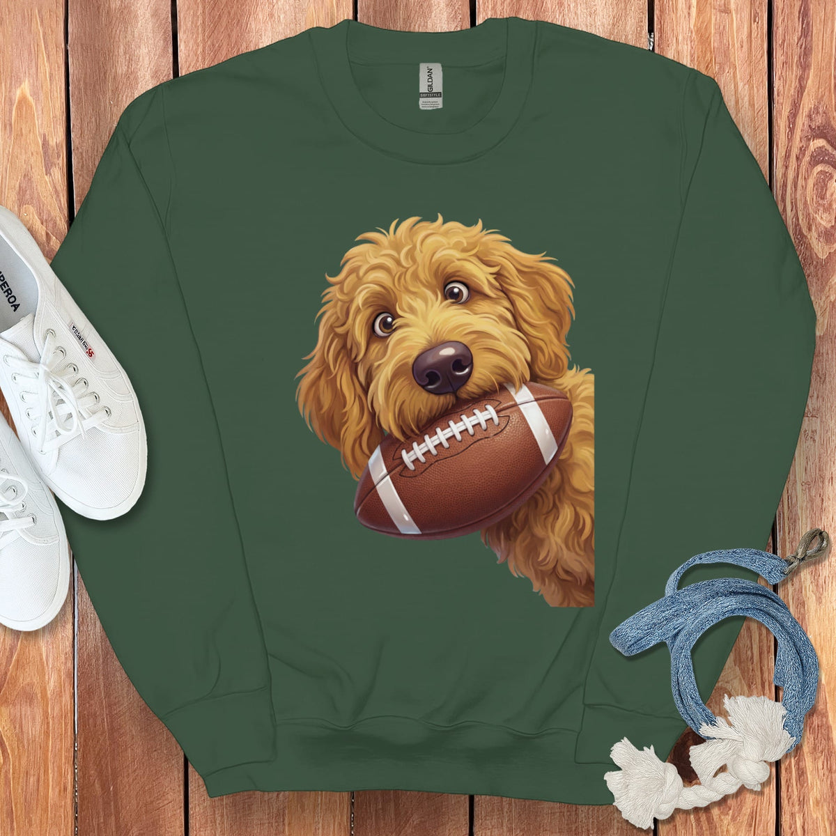 Green sweatshirt with a cartoon doodle dog holding a football.