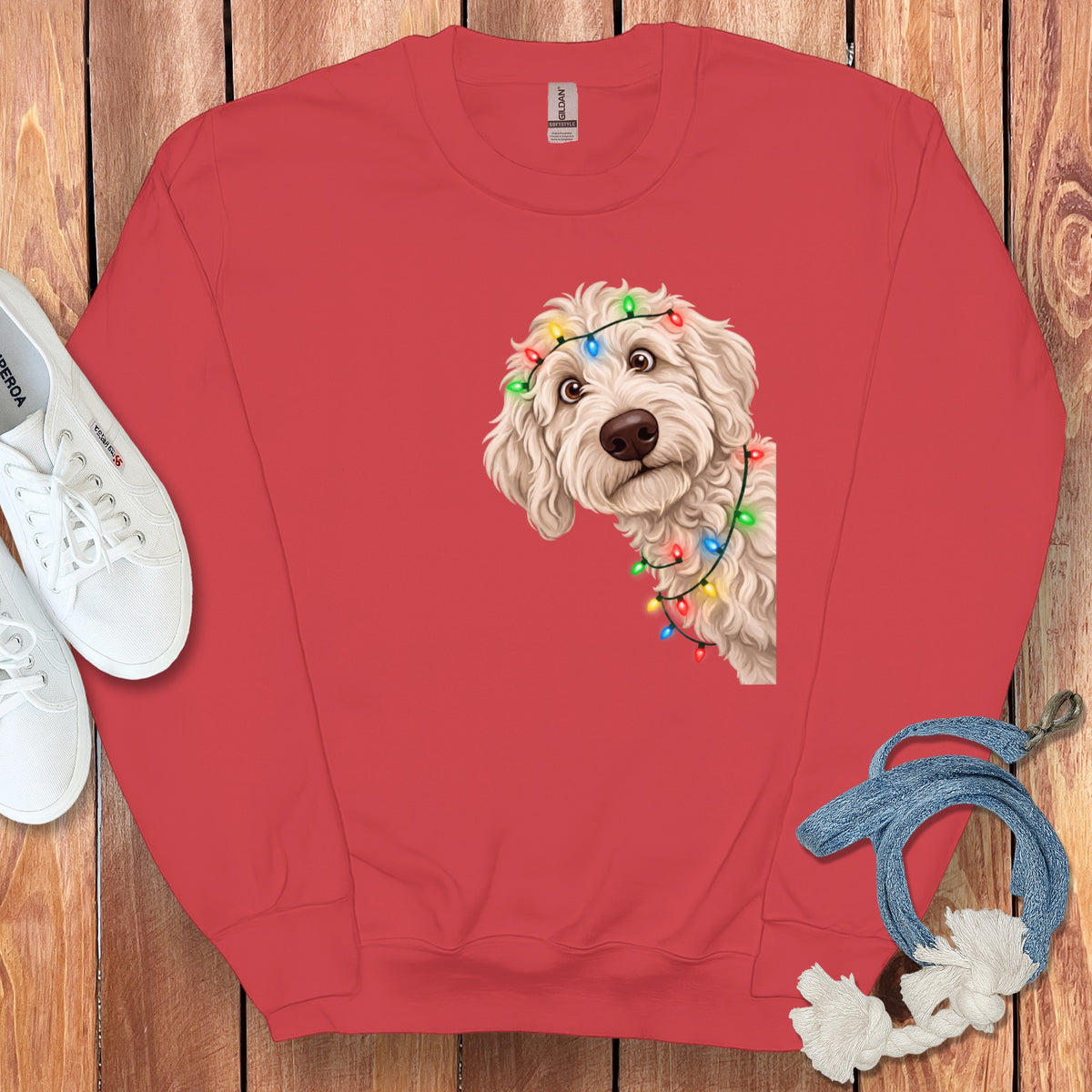 Red sweatshirt with a doodle dog wearing Christmas lights graphic.