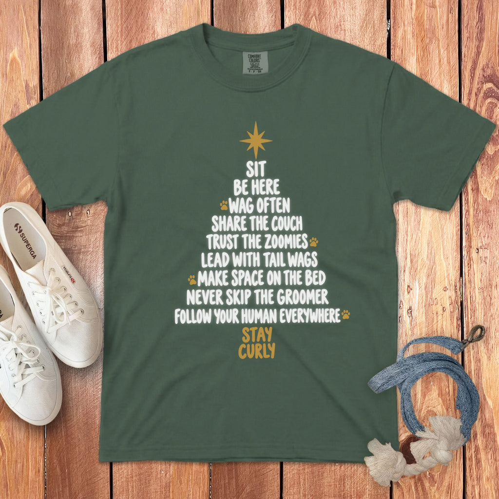 Dark green t-shirt with a white graphic of a Christmas tree made of dog-themed text.