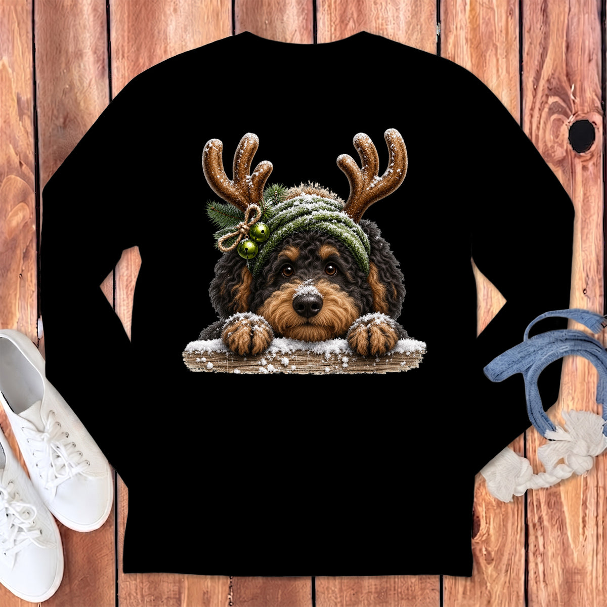 Black long-sleeve shirt featuring a fluffy dog with reindeer antlers and green bells.