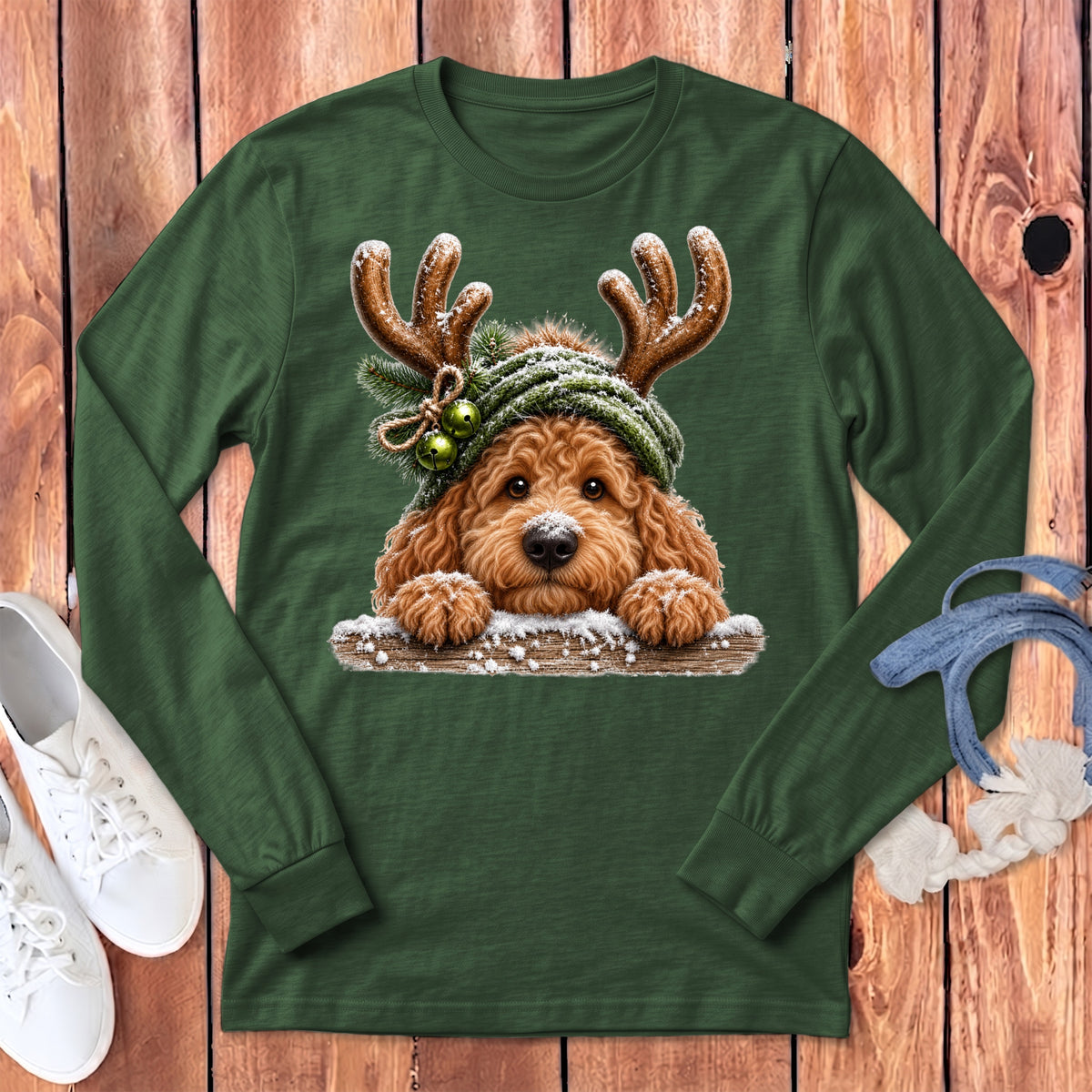 Green long sleeve shirt with a fluffy dog wearing reindeer antlers and a hat.
