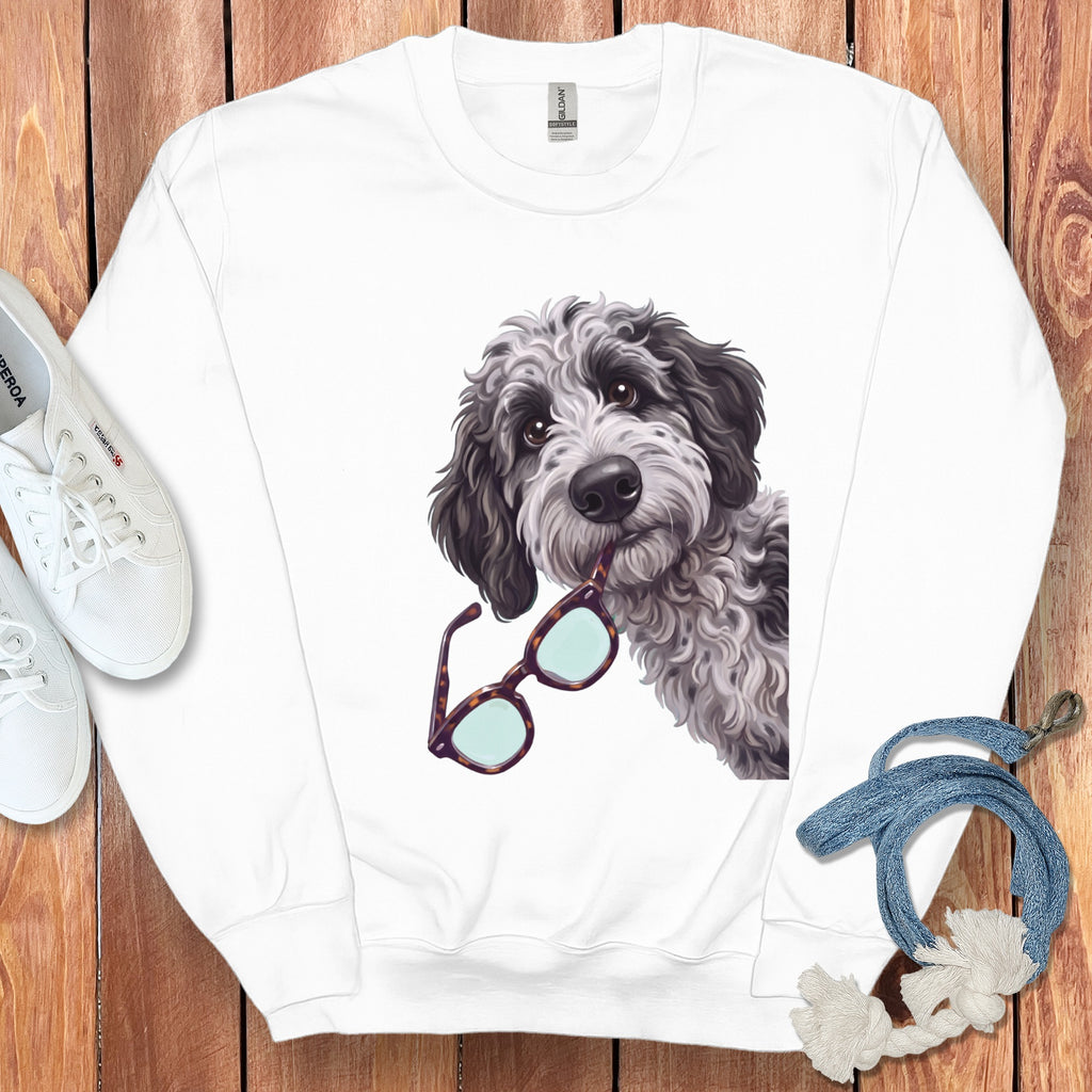 A white crewneck sweatshirt featuring a graphic of a fluffy grey dog holding tortoise shell glasses.