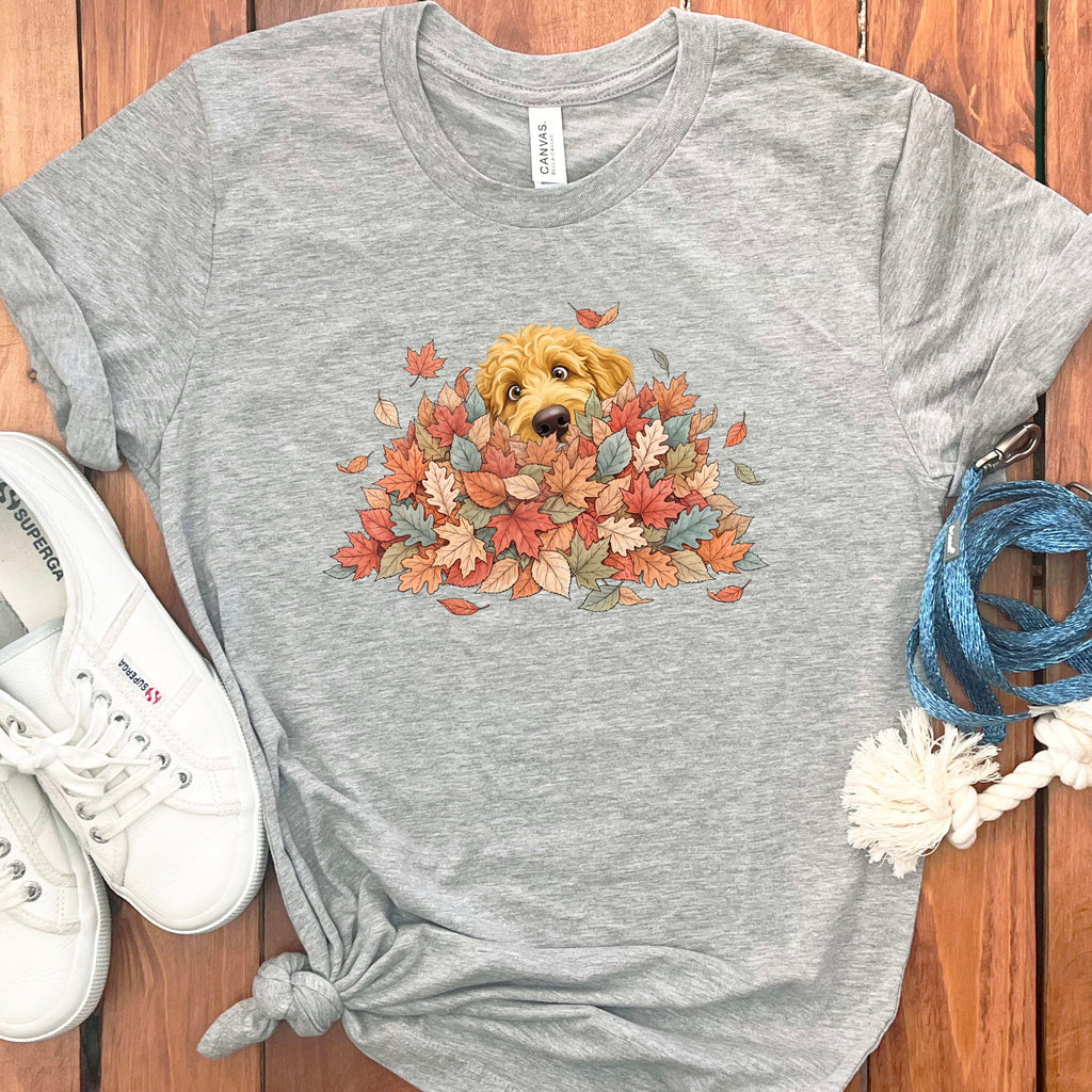 Golden Goldendoodle Peeking Leaf Pile T-Shirt in Athletic Heather / S by Puppy Jo